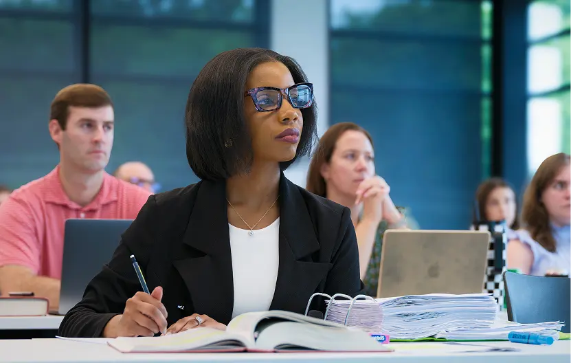 Female student taking notes in class