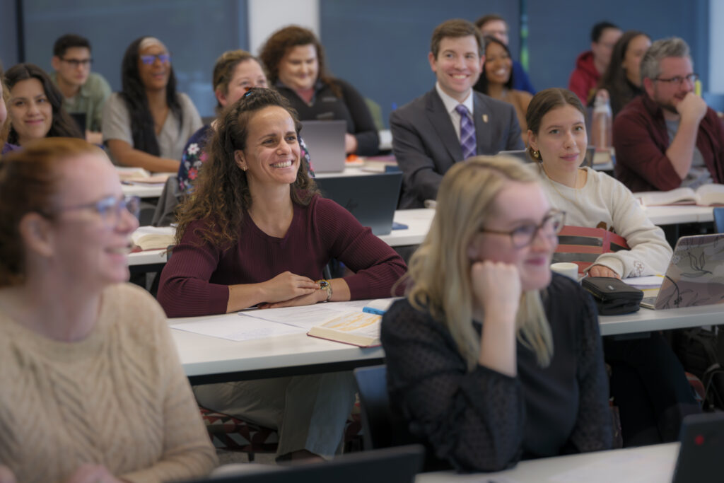 Law students listen and take notes during a full-time class in Elon University’s Charlotte-based law program.